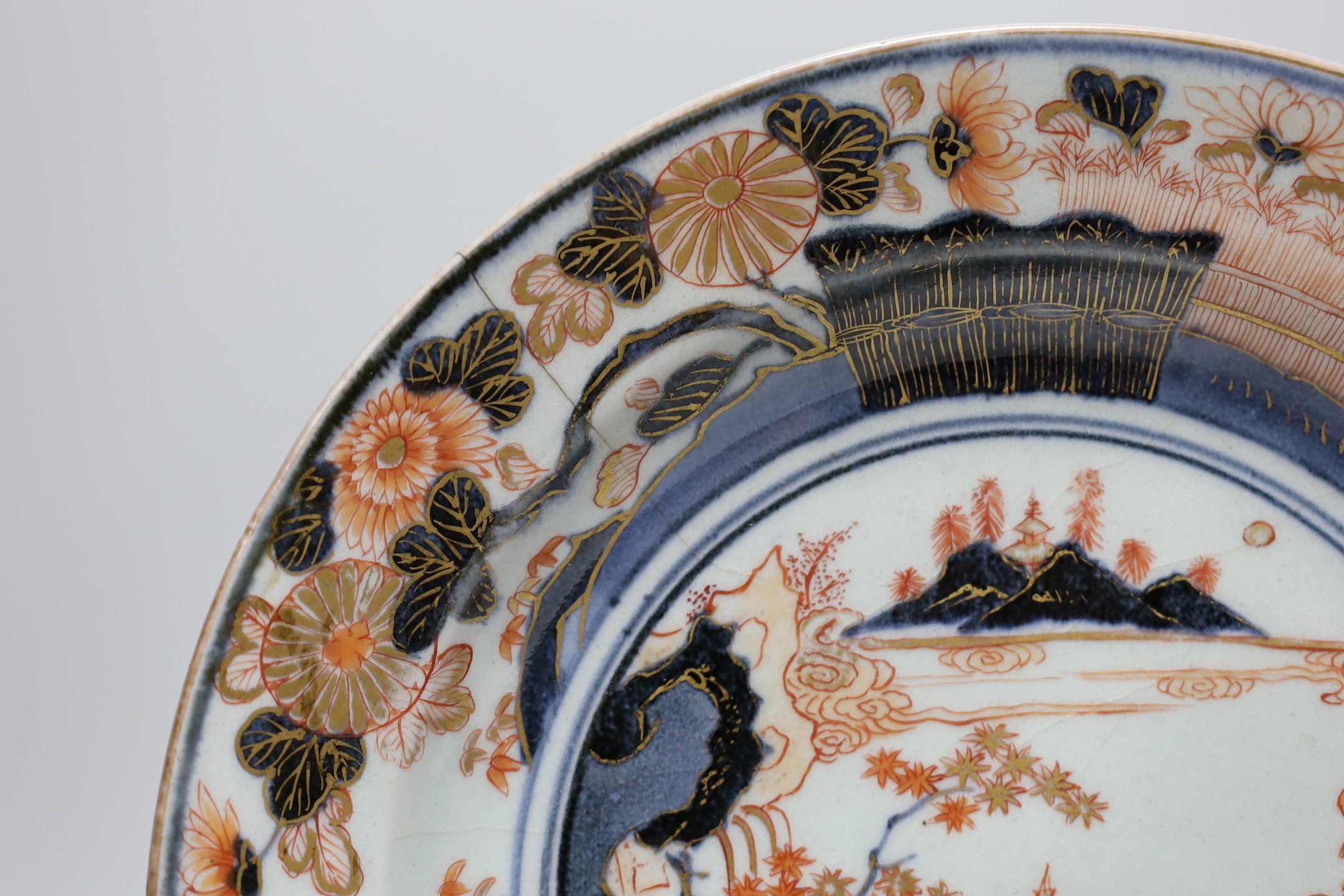 A Japanese Arita dish, late 17th century, painted in Imari palette, stilt marks, cracked, 28cms diameter